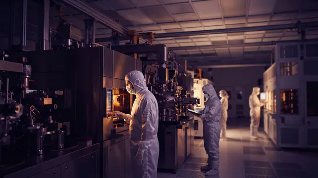 Illustration of cleanroom technicians operating semiconductor fabrication equipment.