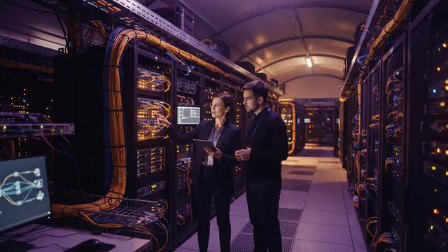 A modern data center with glowing server racks and fiber-optic cabling.