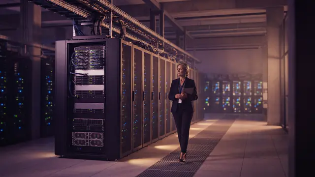 Rows of illuminated server racks inside a modern enterprise cloud data center